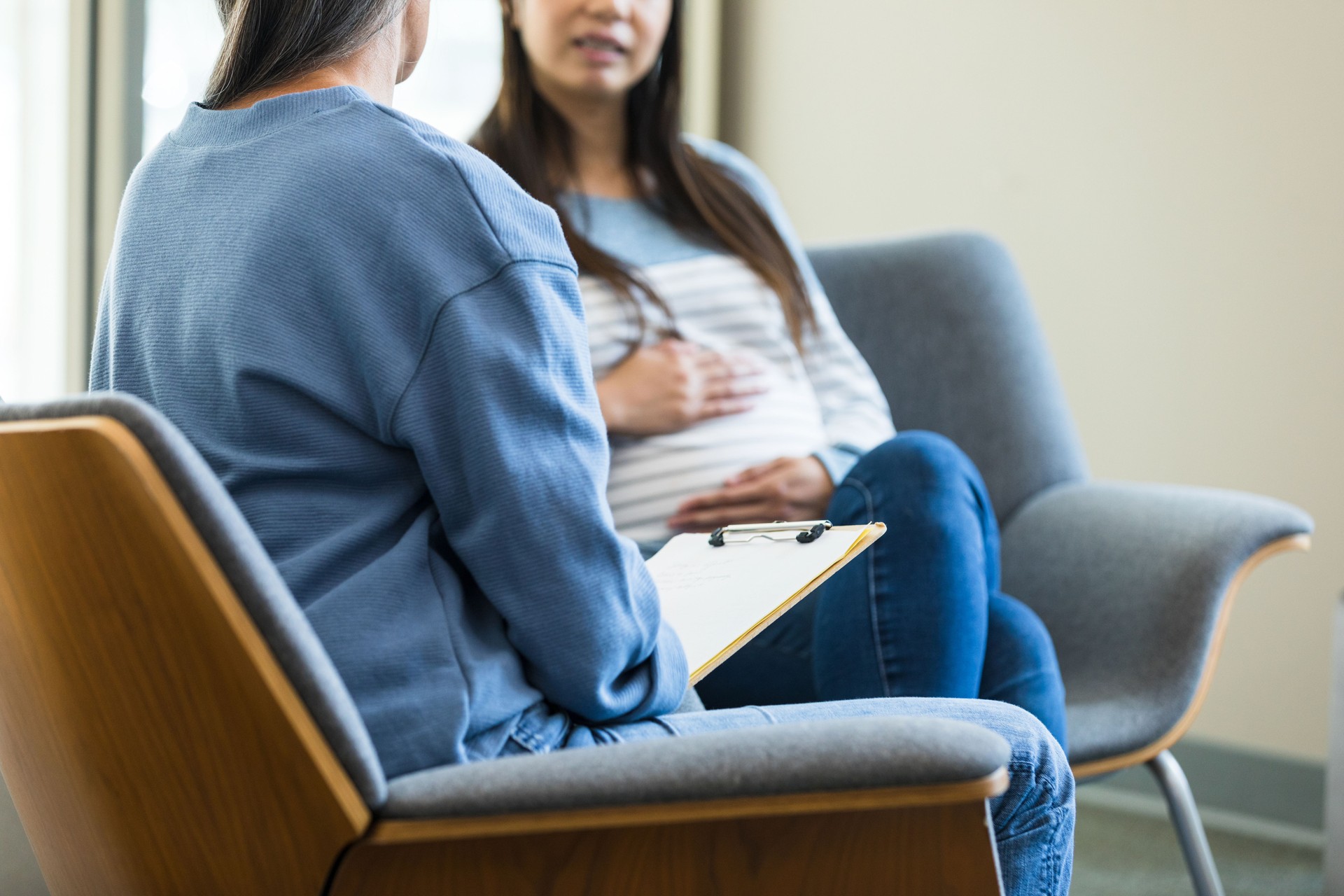 Female therapist and expectant mom have serious conversation